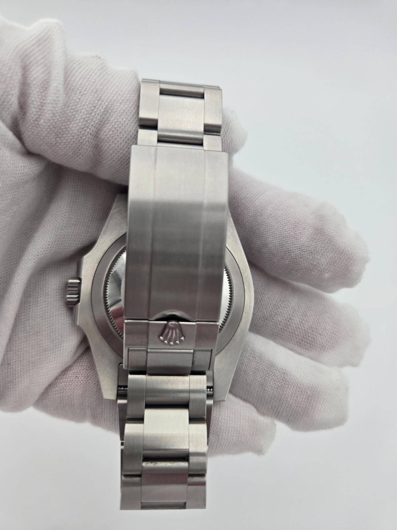 Back of steel watch 126610lv in gloved hand