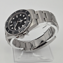 Rolex Submariner 124060 left details of black bezel and oyster bracelet