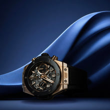 Luxury watch with intricate design on a blue fabric background
