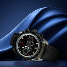 Luxury watch with a black face and silver case on a blue fabric background