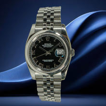 Rolex Datejust 36 with black dial on a blue fabric background