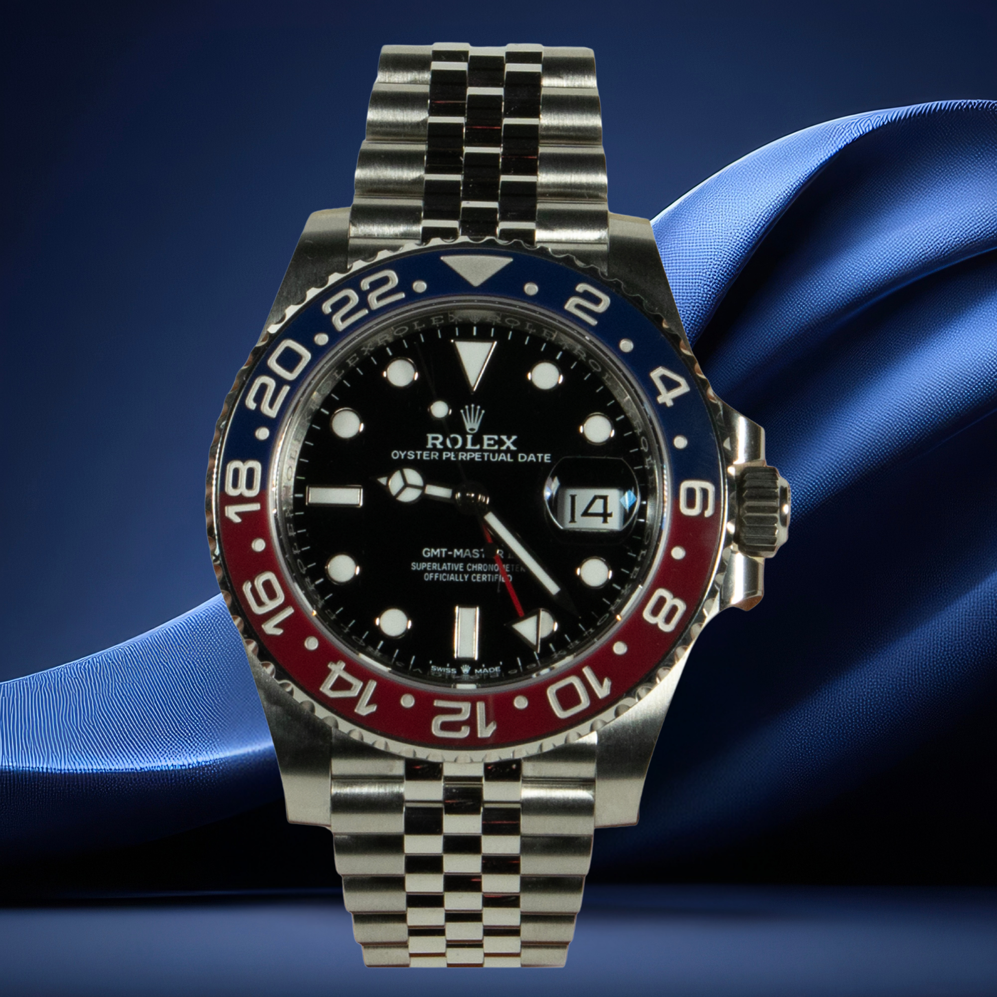 Rolex GMT Master II Pepsi watch with a blue and red bezel on a blue fabric background