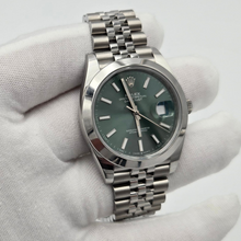 Gloved hand holding Rolex Datejust 41 (126300) - Green Dial & Jubilee Bracelet