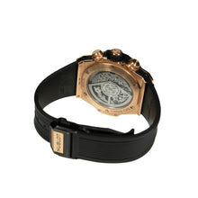 Hublot watch with black strap and gold case on a white background