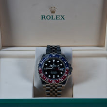 Rolex watch with a red and blue bezel on a white background